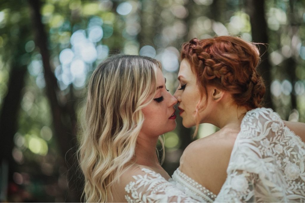 lesbian couple kiss in forest