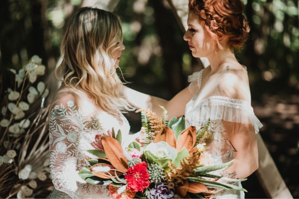 lesbian couple at forest wedding ceremony