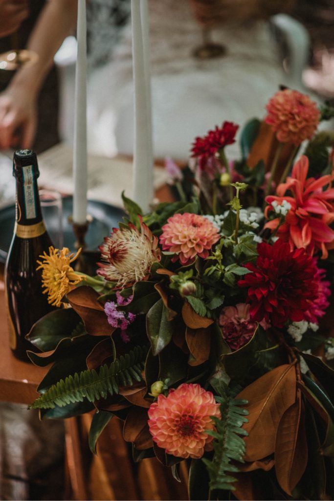 intimate table for two at forest wedding with fall florals