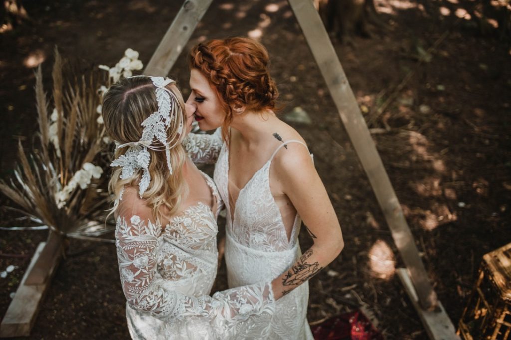 lesbian brides kissing during wedding ceremony