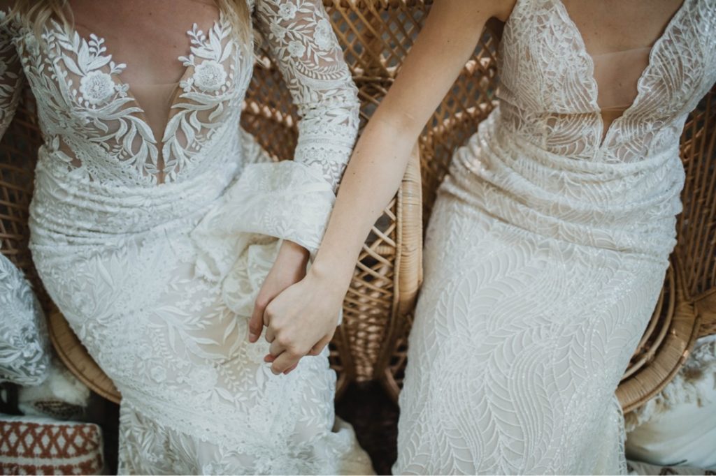 two brides holding hands