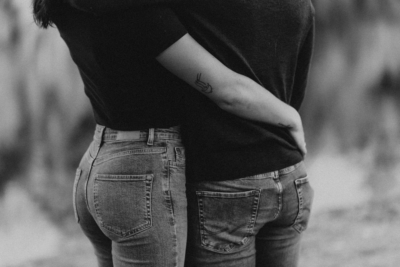 couple hugging in jeans