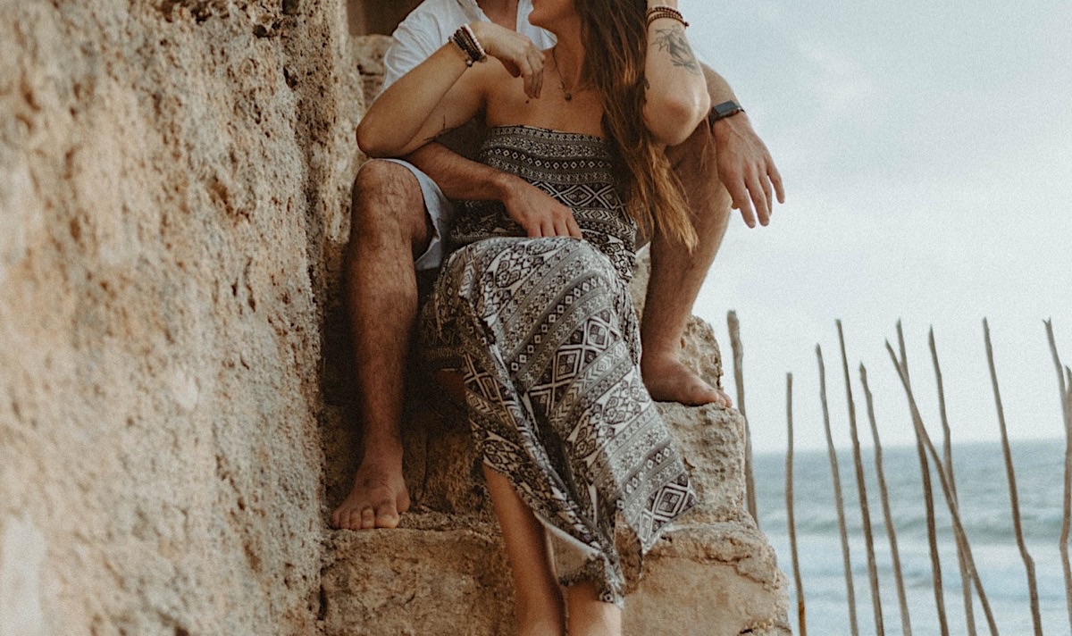 Couple sitting on coral steps near ocean