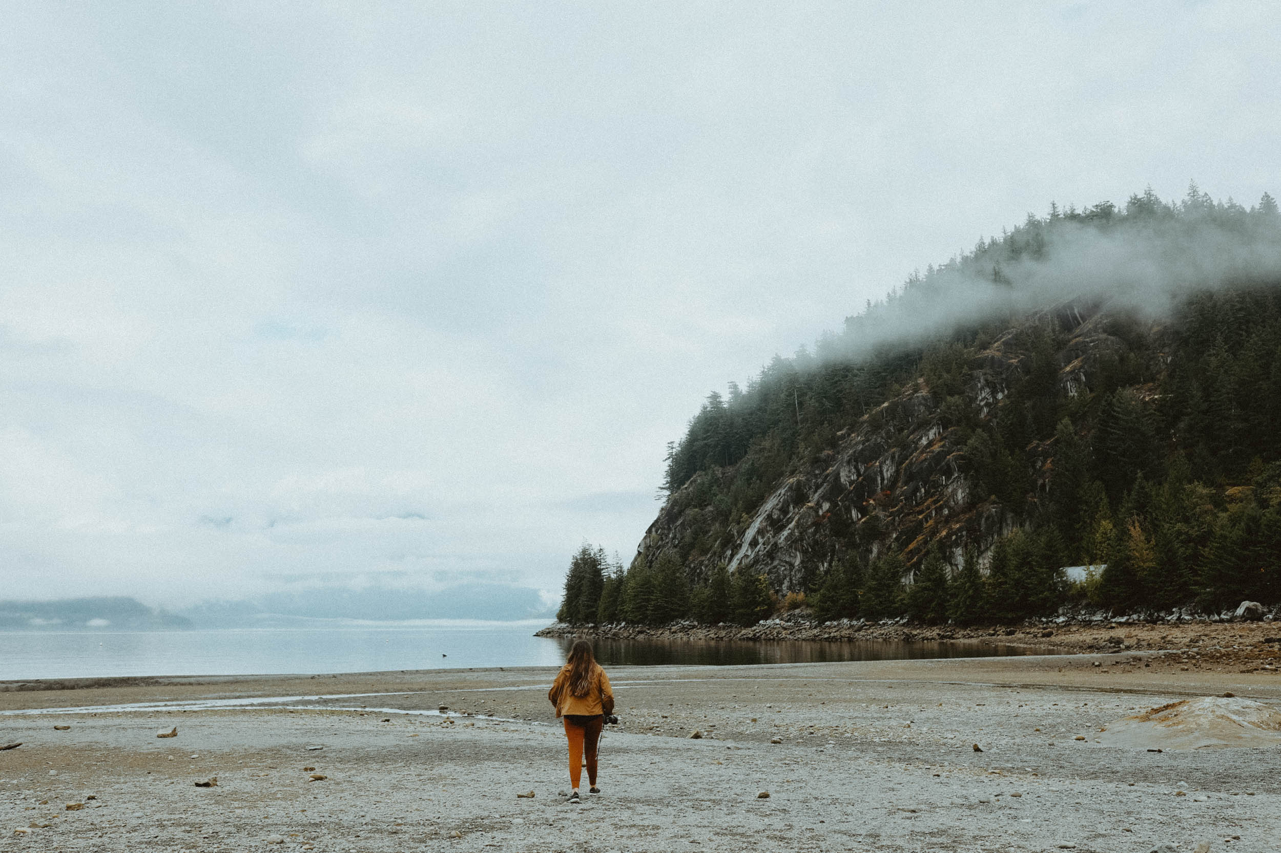 girl walking on misty beach