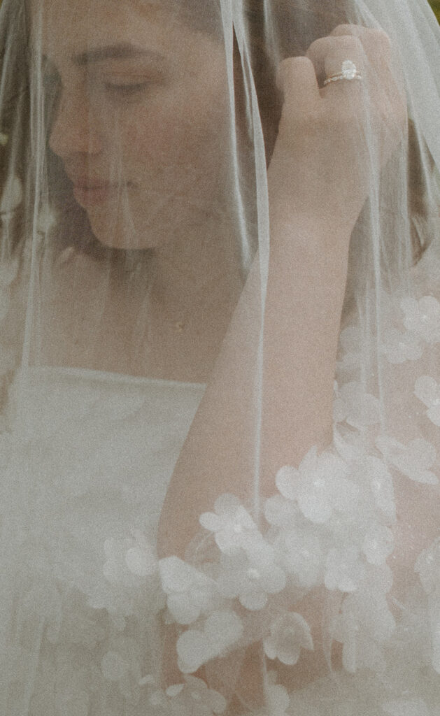 bride wearing floral dress and wedding veil